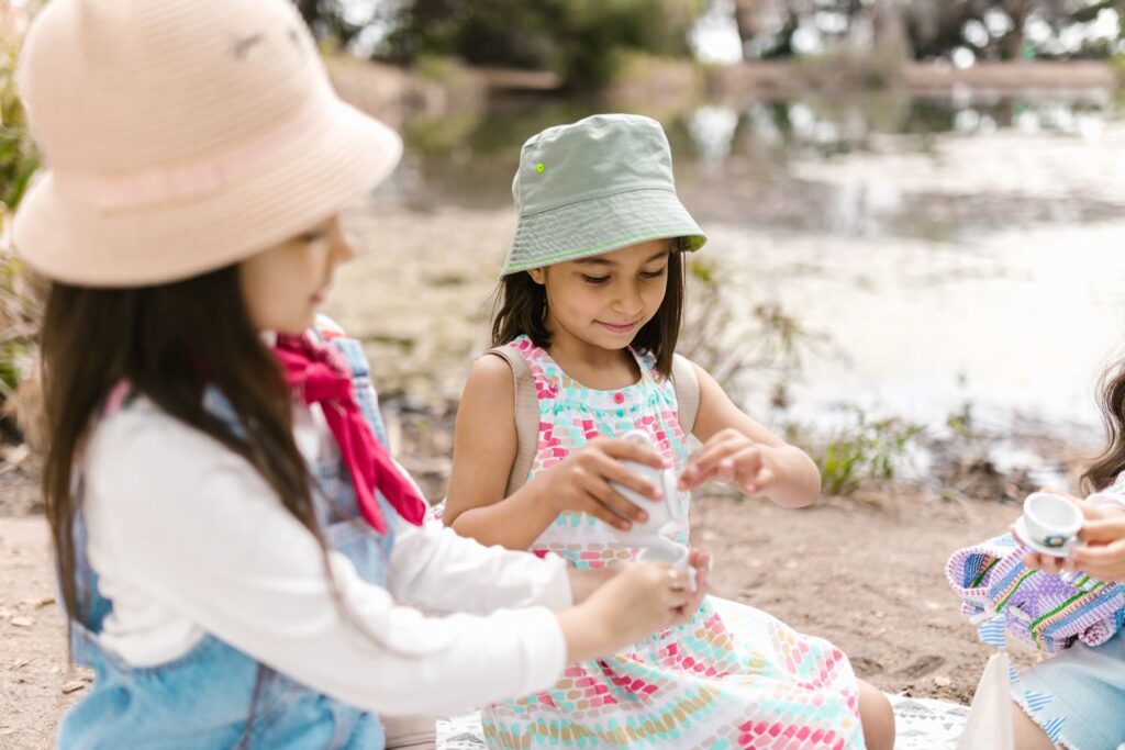 Children having a tea party on the beach